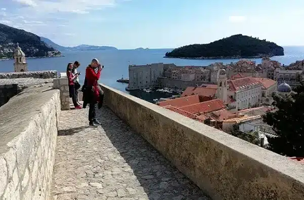 People sightseeing Dubrovnik walls in spring in Croatia.