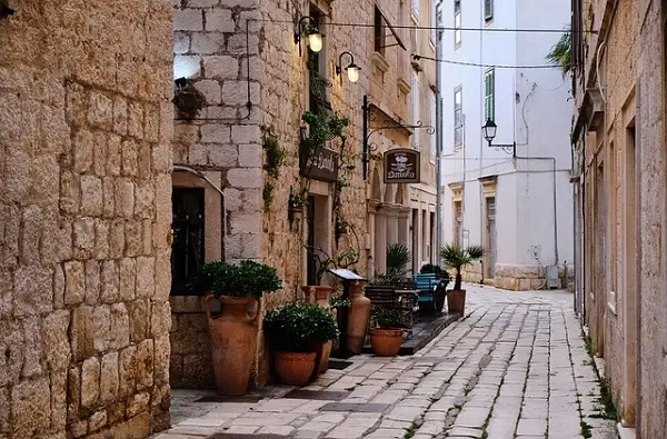Split old town architecture: showing a cobblestone street and old houses.